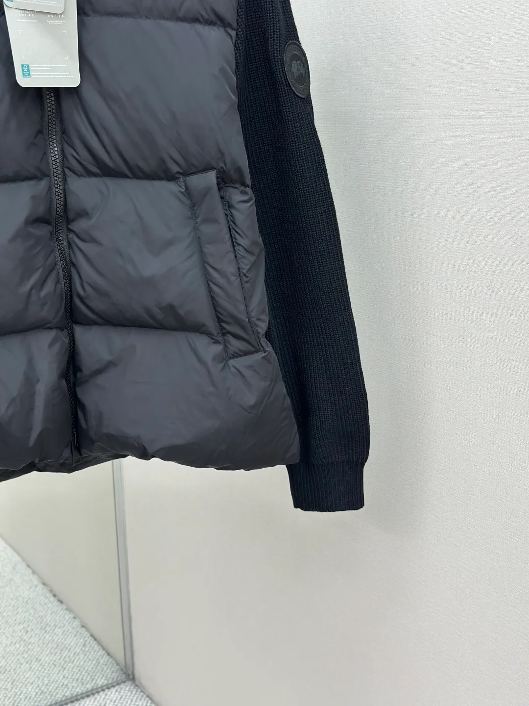 P910 CANADA GOOSE Canada Goose Armband Hooded Down Jacket Fabric selection: The use of high-quality protective nylon fabric not only enhances the wear resistance of the surface, but also takes into account wind resistance, ensuring excellent performance in various harsh weather conditions.  90 national standard high-quality white duck down: selected high-loft down, weighing 170g, light and warm, with excellent temperature locking performance and good resilience.  Three-dimensional quilting process: Precision thread reinforcement to prevent velvet drilling and ensure that the fluffy and resilient elasticity lasts as new.  7-needle medium-thick knitted structure: Use thicker yarns to knit woolen fabrics with obvious thickness and weight. The texture is clearly visible and has a rough, retro texture. It has a good skeleton feel, is relatively stiff, and can maintain the silhouette of clothing for a long time. It also provides more layers of still air to lock in heat.  There is a brand exclusive LOGO on the woolen sleeve arms. It is dark and not obvious in the photo.  Accessories: One-to-one customized logo, one-to-one customized zipper pendant, one-to-one customized snap button SIZE: S M L XL